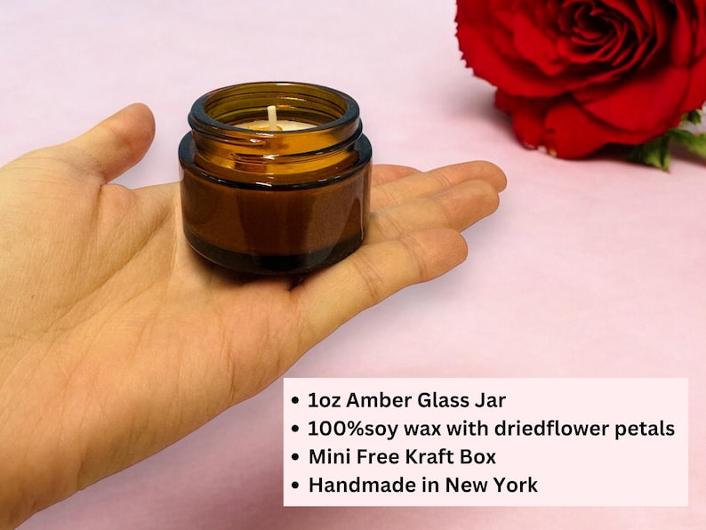 May include: A small 1oz amber glass jar candle containing soy wax with dried flower petals. The text on the image reads: 1oz Amber Glass Jar, 100% soy wax with dried flower petals, Mini Free Kraft Box, Handmade in New York.