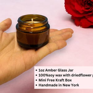 May include: A small 1oz amber glass jar candle containing soy wax with dried flower petals. The text on the image reads: 1oz Amber Glass Jar, 100% soy wax with dried flower petals, Mini Free Kraft Box, Handmade in New York.
