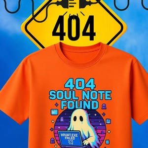 May include: Orange t-shirt with a graphic featuring a ghost, laptop, and the text "404 SOUL NOTE + FOUND". The design includes the text "HAUNT.EXE FAILED" and "Shhh... We're Summoning PLOT TWISTS."