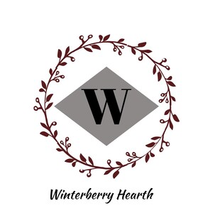 May include: A logo featuring a dark burgundy wreath encircling a gray diamond with a bold black "W". The text "Winterberry Hearth" is written in a cursive font below the wreath.