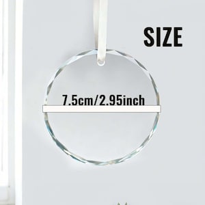May include: A clear, faceted crystal ornament with a white ribbon. The circular ornament has a diameter of 7.5cm (2.95 inches). The word "SIZE" is printed in bold black letters.