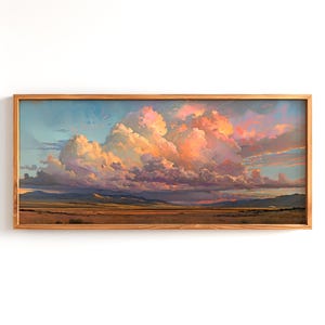 May include: A framed landscape painting depicting a vast, open field with a dramatic, colorful sunset sky. The sky is filled with large, fluffy clouds, some of which are illuminated with a warm, pink glow. The field is a muted green, and the distant mountains are a hazy blue.