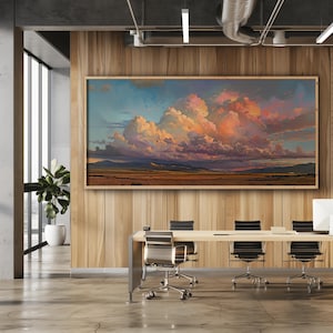May include: A large framed painting of a dramatic sunset over a desert landscape. The sky is filled with vibrant pink, orange, and purple clouds. The painting is hanging on a wood-paneled wall in a modern office setting.