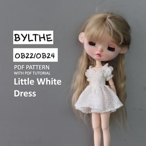 May include: A white dress with a ruffled neckline and short sleeves. The dress is designed for a Blythe doll, specifically for the OB22/OB24 size. The text "BYLTHe OB22/OB24 PDF PATTERN WITH PDF TUTORIAL Little White Dress" is displayed on a gray background.