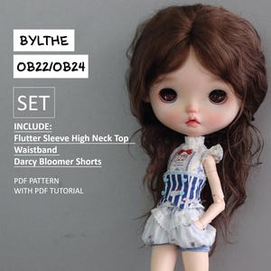 Op de afbeelding: Een pop die een blauw-wit gestreept topje draagt met een witte kraag met ruches en een witte bloomer. De pop heeft bruin haar en blauwe ogen. De tekst "BYLTHE OB22/OB24 SET INCLUDE: Flutter Sleeve High Neck Top Waistband Darcy Bloomer Shorts PDF PATTERN WITH PDF TUTORIAL" is gedrukt op een grijze achtergrond.