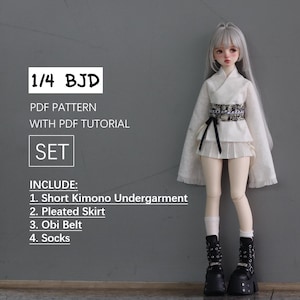 May include: A 1/4 BJD doll wearing a white kimono with a black obi belt, a white pleated skirt, and black socks and shoes. The doll is standing on a grey background. The text "1/4 BJD" is in a white box at the top of the image. The text "PDF PATTERN WITH PDF TUTORIAL SET" is below the box. The text "INCLUDE: 1. Short Kimono Undergarment 2. Pleated Skirt 3. Obi Belt 4. Socks" is below the text "SET".