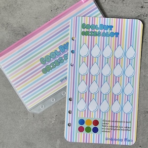 May include: A savings tracker insert with a pastel vertical striped background and the text COOL BUT CRIES ALOT. It features twenty white teardrop outlines for colouring, a colour-coded legend, and instructions for a dice-based savings game.