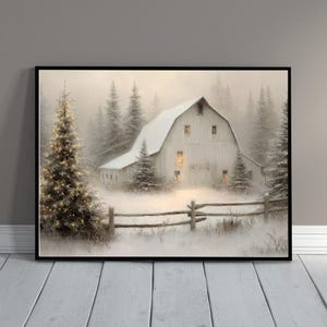 May include: A framed winter landscape print featuring a white barn covered in snow, surrounded by snow-covered pine trees. A wooden fence is in the foreground. The barn's windows glow with warm light, and a Christmas tree is lit with golden lights.