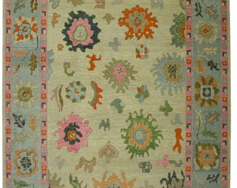 Handmade Beige Oushak Rug: Turkish Knots, Pink Orange Green Tribal Motifs