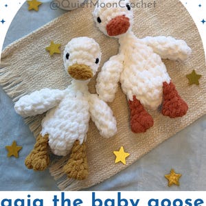 May include: Two handmade crochet baby goose toys. The geese are white with orange beaks and feet. The text "Gaia the baby goose finished lovey" is at the bottom of the image. The Baby Birds Collection.