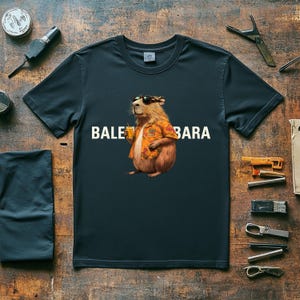 May include: A dark blue t-shirt with a cartoon image of a guinea pig wearing sunglasses and a Hawaiian shirt. The text "BALE BARA" is printed on the shirt.