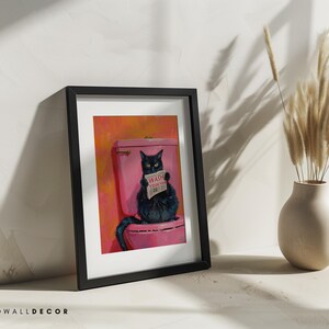 May include: A framed painting of a black cat sitting on a pink toilet with a sign that says "Wash Your Paws" in a bathroom setting.
