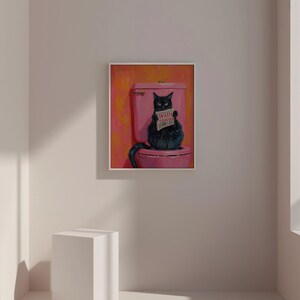 May include: A black cat sitting on a pink toilet with a sign that says "Wash Your Paw" in a bathroom setting.