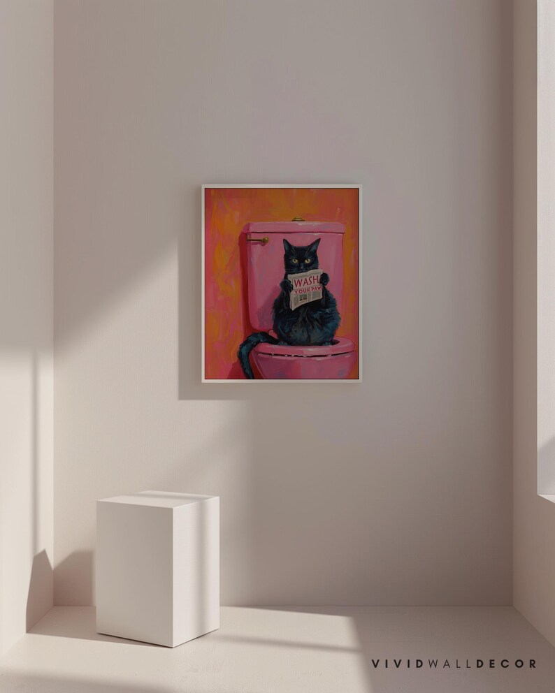 May include: A black cat sitting on a pink toilet with a sign that says "Wash Your Paw" in a bathroom setting.