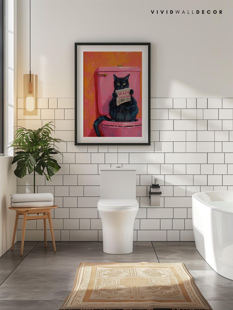 May include: A black cat sitting on a pink toilet with a sign that says "Wash Your Paws" in a bathroom with white tile walls. The cat is holding a newspaper in its paws.