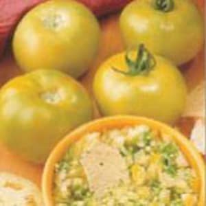 May include: Four green tomatoes, some with stems, are arranged on a table with a bowl of food in the center. The tomatoes are a pale green color and appear to be ripe.