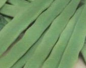 May include: A close-up of a bunch of green string beans. The beans are arranged in a pile, with the tips of the beans pointing in different directions.