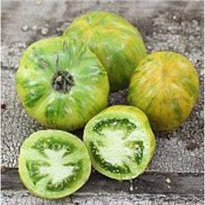 May include: Four green tomatoes with yellow stripes. Two tomatoes are whole and two are cut in half, revealing the green flesh and seeds.