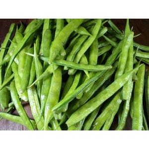 May include: A pile of fresh green guar beans, also known as cluster beans, ready for cooking.