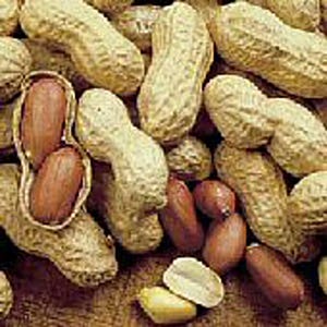 May include: A close-up of a pile of peanuts in their shells. The peanuts are a light brown color and have a rough texture. Some of the peanuts are cracked open, revealing the brown peanut kernels inside.