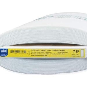 May include: A roll of white 71F Peltex I Ultra Firm 1-Sided Fusible fabric. The label indicates it is 100% polyester and 20 inches wide. The product is for crafts and home decor. Made in the USA.