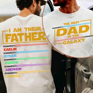 May include: White t-shirt with the text "I AM THEIR FATHER" in gold, and the names KAELIN, RYKER, JOSEPH, ANDREW, and GEORGE below. The shirt also features the text "THE BEST DAD IN THE GALAXY" in gold.