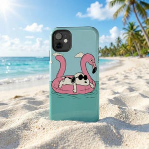 May include: A white ceramic mug with a black handle and the text "But First, Coffee" in a handwritten style. The mug is on a white surface. The mug is approximately 10 cm tall.