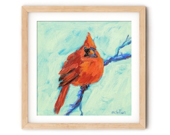 May include: A square framed painting of a bright red cardinal bird perched on a blue branch against a light mint green background. The artwork features visible brushstrokes and the artist's signature, mclellan, in the bottom right corner.