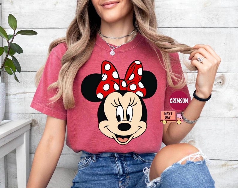 May include: A white ceramic mug with a black handle and the text "But First, Coffee" in a bold, black font. The mug is set against a blurred background, suggesting a cozy setting.