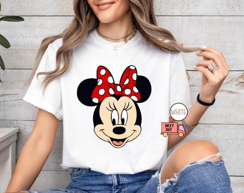 May include: A white ceramic mug with a black handle and the text "But First, Coffee" in a black, handwritten-style font. The mug is on a white surface.