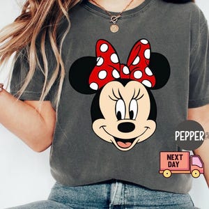 May include: A white ceramic mug with a black handle and the text "But First, Coffee" in a black, bold font. The mug is sitting on a white surface. The mug is approximately 4 inches tall.