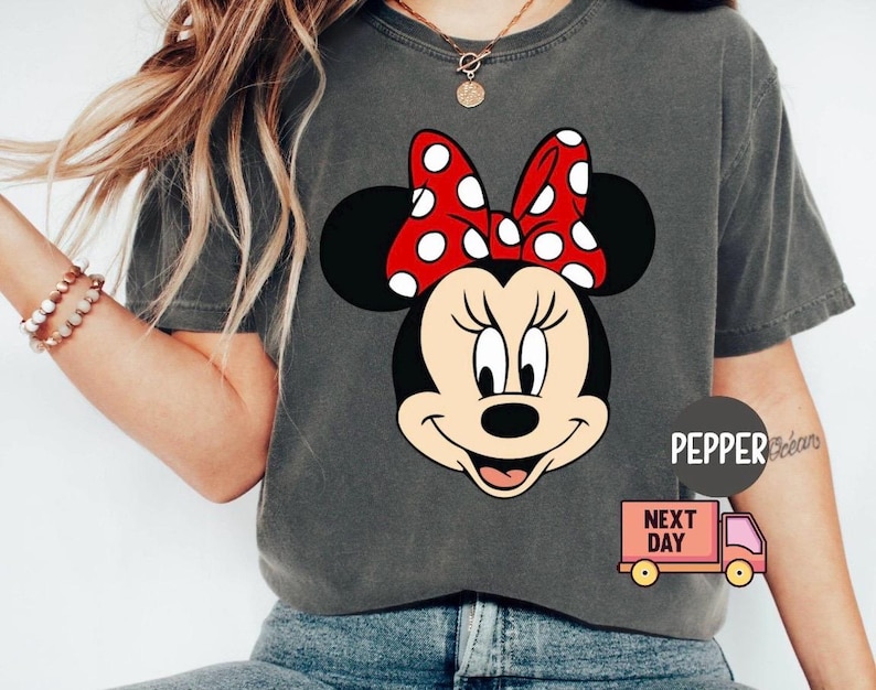 May include: A white ceramic mug with a black handle and the text "But First, Coffee" in a black, bold font. The mug is sitting on a white surface. The mug is approximately 4 inches tall.