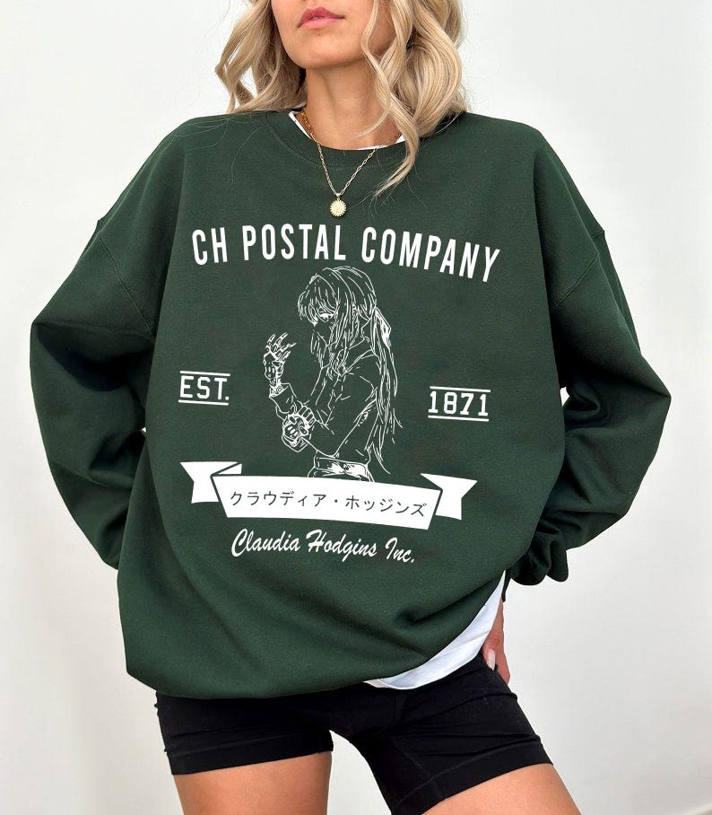 May include: Dark green sweatshirt with white text and graphic. The text reads "CH POSTAL COMPANY" above a detailed illustration of a person. Below the illustration is a banner with Japanese text and "Claudia Hodgins Inc." The sweatshirt also has "EST. 1871".