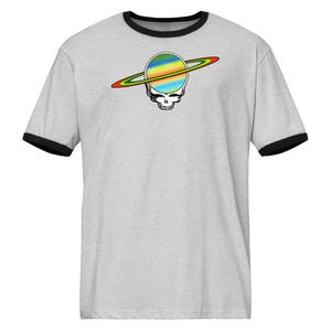May include: A light gray ringer t-shirt with a black collar and sleeves. The shirt features a colorful graphic of a skull with a planet and ring design. The planet is a mix of blue, green, yellow, and orange.