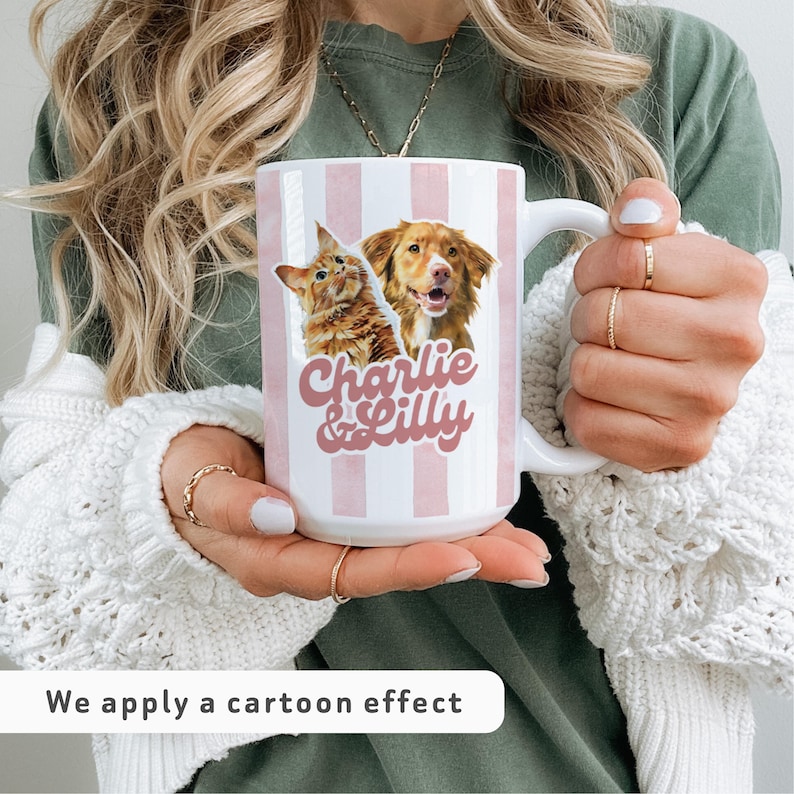 May include: White ceramic mug with pink vertical stripes, featuring cartoon images of a cat and a dog, and the text "Charlie & Lilly". The mug has a large handle.