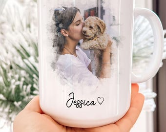 May include: White ceramic mug with a custom photo and text. The mug features a watercolor-style image of a person kissing a small dog. The name "Jessica" is written in cursive with a heart symbol. The text "custom Photo + Text" is also visible.