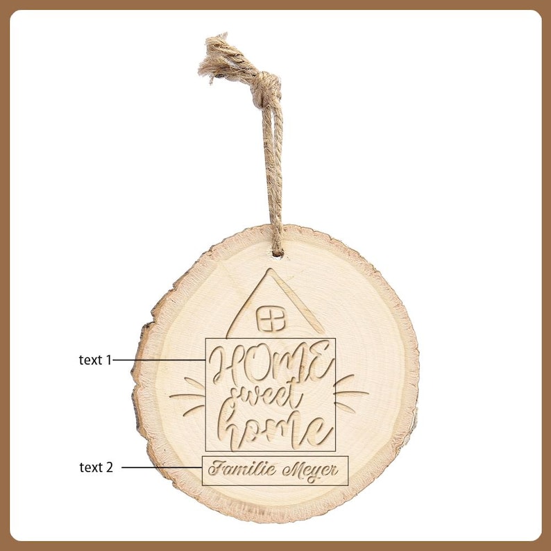 May include: A round wooden ornament with a natural wood grain finish. The ornament features the words "HOME sweet home" and "Familie Meyer" engraved within a house outline. A jute twine loop is attached for hanging.
