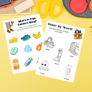May include: Two activity sheets for children with colorful illustrations and text. One sheet asks "What's in Frigo Camelo's Belly?" and the other is "Color by Word!" The sheets are on a yellow surface with art supplies.