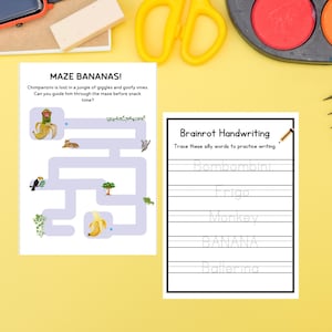 May include: Two activity sheets on a yellow surface. One sheet is a maze titled "MAZE BANANAS!" with a chimpanzee and banana illustrations. The other sheet is for handwriting practice with the title "Brainrot Handwriting".