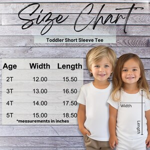 May include: A size chart for toddler short sleeve tees, with measurements in inches. The chart lists age, width, and length for sizes 2T to 5T. Two children wearing white t-shirts are shown, with the width and length of the shirt indicated.