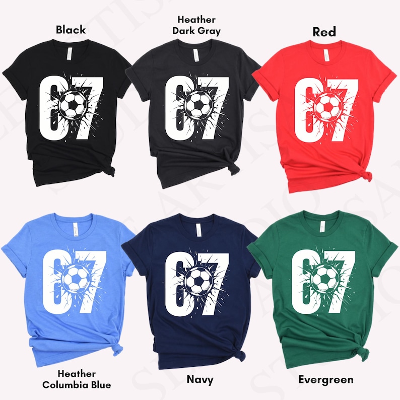 May include: A collection of six short-sleeved t-shirts in various colors: black, heather dark gray, red, heather columbia blue, navy, and evergreen. Each shirt features a white graphic of the number 67 with a soccer ball in the center.