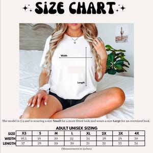 May include: White t-shirt with a size chart graphic. The chart displays adult unisex sizing in inches, ranging from XS to 4X. The model is 5'4" and wearing a Small for a fitted look and a Large for an oversized look. The text "SIZE CHART" is at the top.
