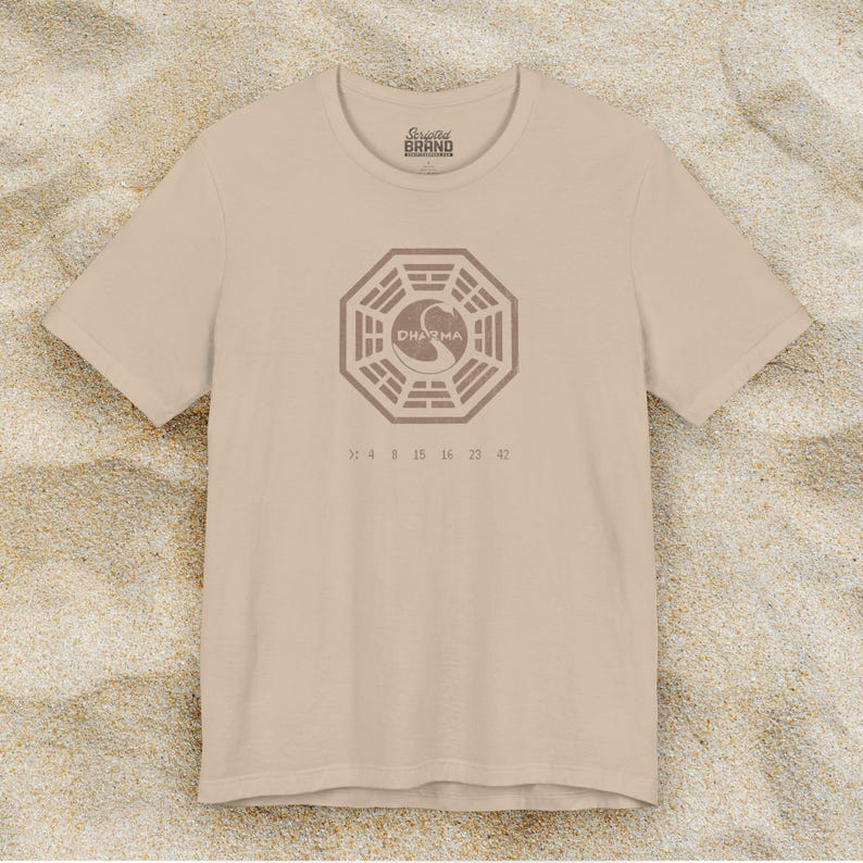 Tan short-sleeve t-shirt featuring the Dharma Initiative swan logo graphic from the TV show LOST in a vintage distressed style.