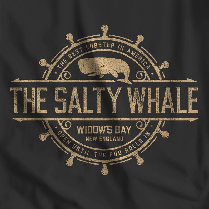 Closeup of black 'The Salty Whale' vintage distressed pub logo t-shirt inspired by Widow's Bay Apple TV series, soft Bella+Canvas cotton tee