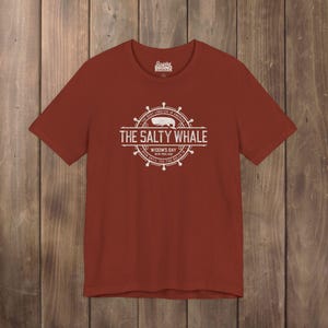 Rust red The Salty Whale vintage distressed pub logo t-shirt inspired by Widow's Bay Apple TV series, soft Bella+Canvas cotton tee