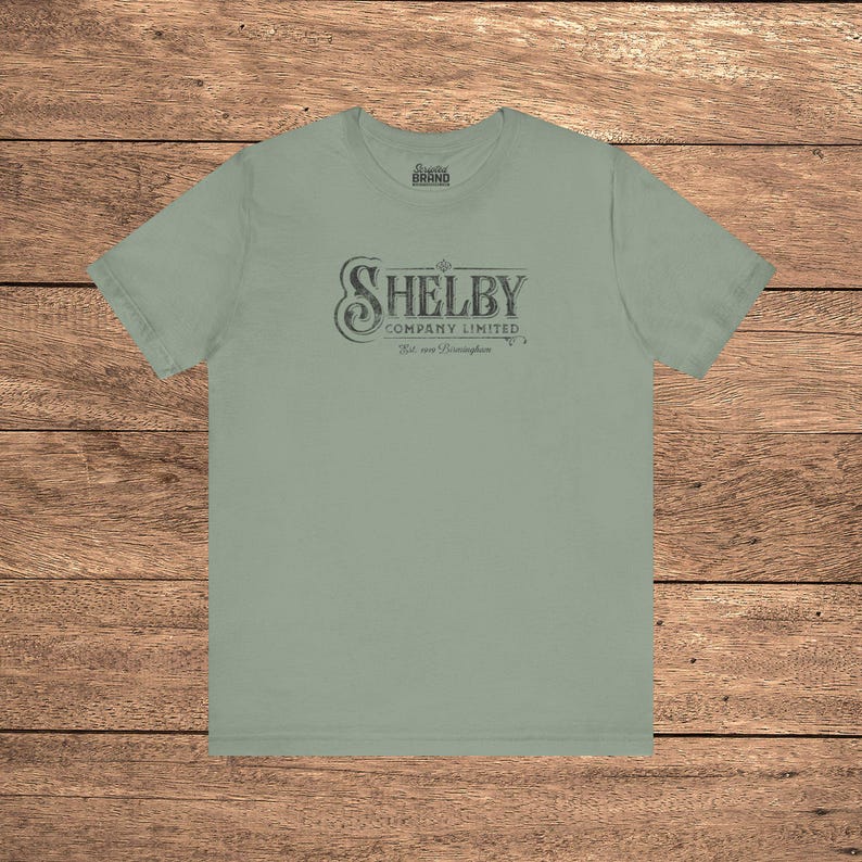 Sage green Bella+Canvas 3001 t-shirt featuring a vintage Shelby Company Limited logo from Peaky Blinders.
