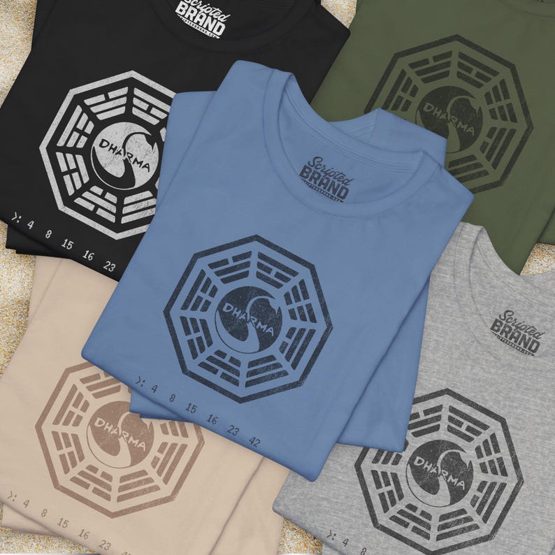 Group of 5 folded short-sleeve t-shirts featuring the Dharma Initiative swan logo graphic from the TV show LOST in a vintage distressed style.