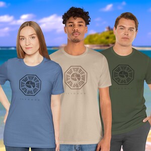 Models wearing short-sleeve t-shirts featuring the Dharma Initiative swan logo graphic from the TV show LOST in a vintage distressed style.
