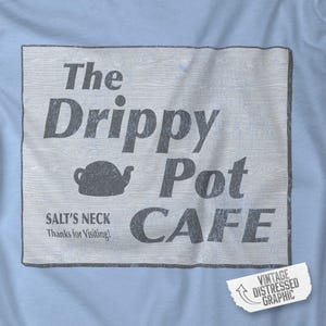 May include: A vintage distressed graphic design for a cafe called "The Drippy Pot Cafe" with the text "Salt's Neck Thanks for Visiting!"  The graphic features a teapot and a woodgrain background.