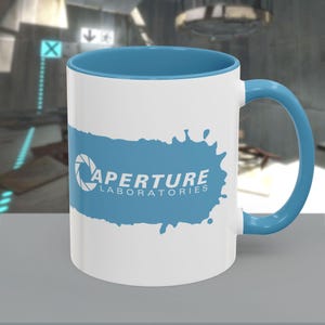 May include: A set of three ceramic mugs with a speckled, matte finish. The mugs are in shades of cream, light gray, and dark gray. Each mug has a simple, minimalist design and a rounded handle.